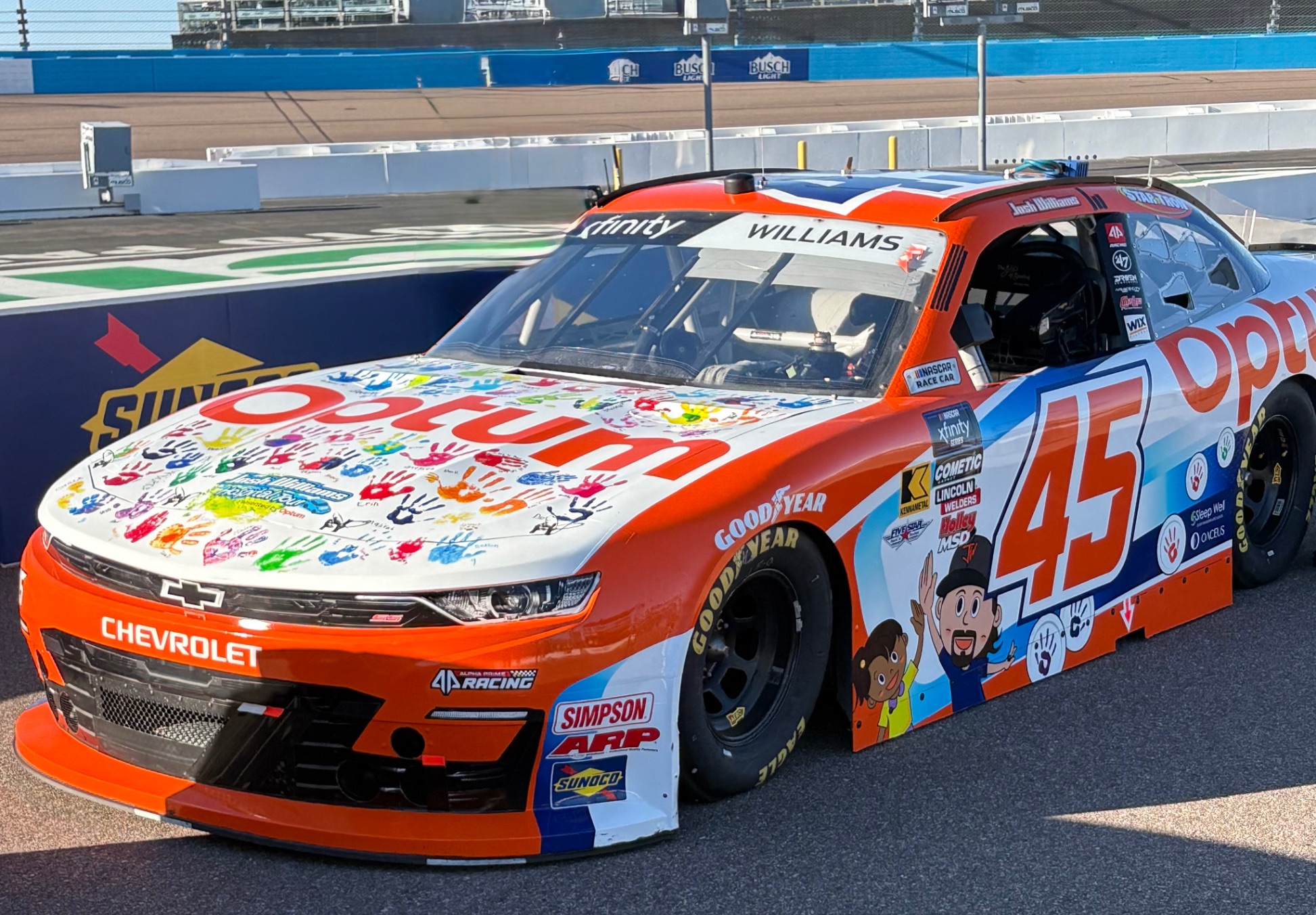 Josh Williams with a young patient — handprint car program